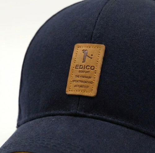 Navy blue cap with a brown leather patch featuring the Edico logo on a white background.
